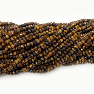 Macro shot of 3-4mm natural faceted tiger eye stone beads with golden chatoyancy luster