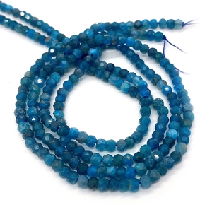 Macro shot of natural faceted blue apatite round beads for DIY jewelry making
