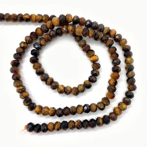 Macro view of faceted natural tiger eye stone beads with polished brown texture for DIY