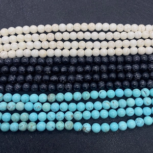 Macro detail of round natural stone beads in white, blue, and black for DIY jewelry