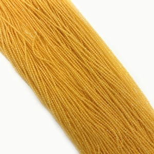 Macro view of multi-faceted 2mm golden opal beads for DIY jewelry making and crafts