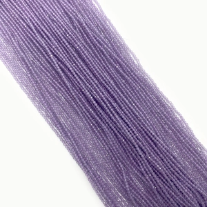 Close-up of small 2-3mm purple faceted round cat eye stone beads with shimmering finish