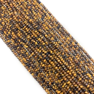 Close-up of faceted Tiger Eye stone beads showing natural brown and black silk luster