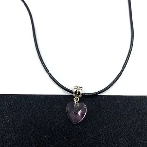 Macro detail of the purple faceted crystal heart pendant with silver textured bail