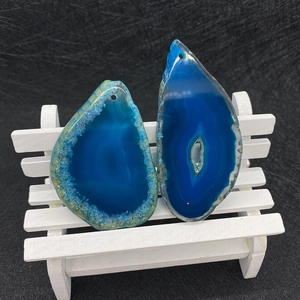 Detailed close-up of blue natural agate pendants with raw edges and pre-drilled holes