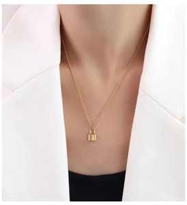 Detail of 18k gold plated choker featuring a padlock pendant on a female model