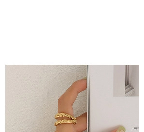 Detail of gold-plated titanium steel ring with lava hammer texture and wrap design