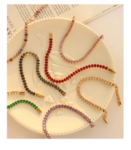 Detailed macro view of colorful oval-cut gemstone tennis bracelets in gold plating