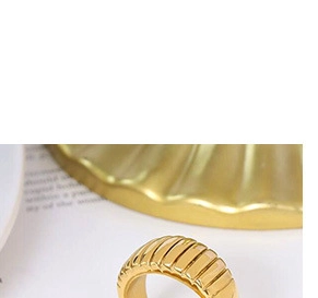 Close-up of a 18k gold plated bracelet with retro vertical textured pleated design