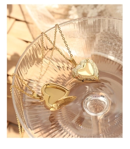 Détail d'un collier médaillon cœur vintage ouvrant plaqué or 18 carats avec gravures