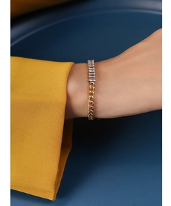 Detail view of 18k gold plated chain bracelet with rectangular zircon stones and Cuban links