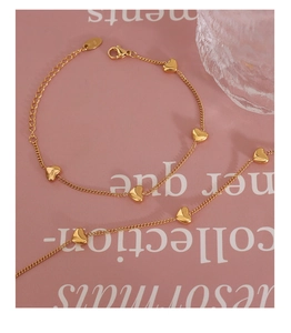 Close-up of golden heart bracelet with lobster clasp and adjustable extension chain