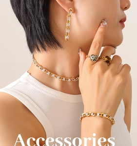 Detailed view of model wearing gold jewelry set with zircon necklace and marble stone rings