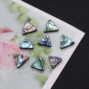 Macro detail of triangle abalone shell beads showing natural colorful iridescent luster