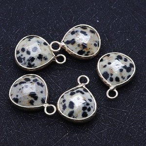 Detail of five teardrop Dalmatian Jasper pendants with gold-plated edges and facets