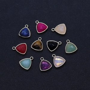 Detailed macro view of faceted triangle gemstone pendants in diverse vibrant colors