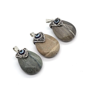 Natural teardrop agate stone pendant with sparkling evil eye design and silver clasp