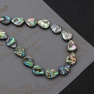 Macro shot of colorful iridescent teardrop abalone shell beads for DIY jewelry making