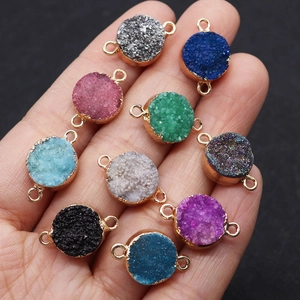 Macro shot of 10 colorful druzy quartz connectors with gold plated edges for DIY jewelry