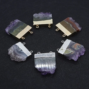 Detail of natural amethyst pendants with gold and silver plated metal trim and dual loops
