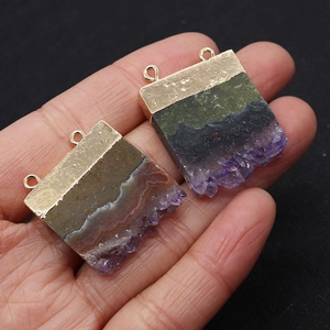 Close-up of irregular amethyst pendant with gold plated double loop connectors