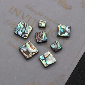 Macro detail of square abalone shell beads with natural iridescent luster for DIY jewelry