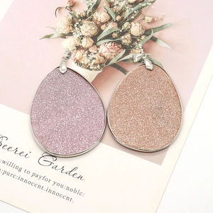 Natural shell teardrop pendant with pink and gold glitter finish and silver metal frame