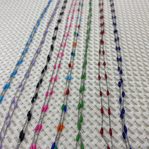 Detail view of colorful enamel rice bead chains in 8 vibrant colors for jewelry making DIY