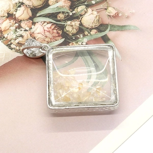 Rhombus silver metal pendant with natural yellow crystal stone chips and ornate bail