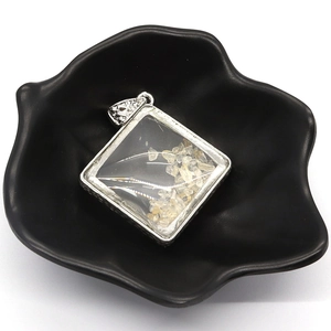 Silver square pendant with natural yellow crystal stones in a geometric glass frame