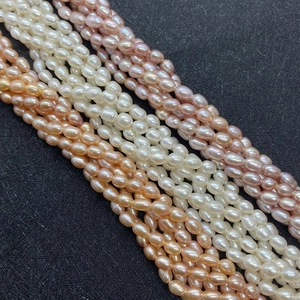 Macro shot of 3A grade natural freshwater rice pearls in white, pink, and purple colors
