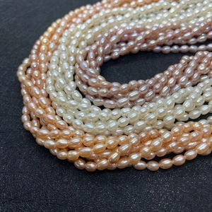 Macro shot of Grade 3A rice-shaped freshwater pearls in pink, white, and lilac hues