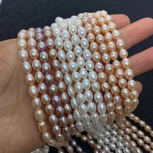 Close-up of AAA natural freshwater oval pearls in white, pink, and purple tones