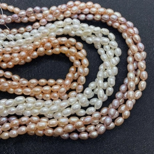 Macro shot of high-luster rice-shaped natural freshwater pearls in multi-color strands