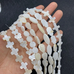 Natural white mother of pearl shell beads in hamsa hand butterfly and leaf shapes