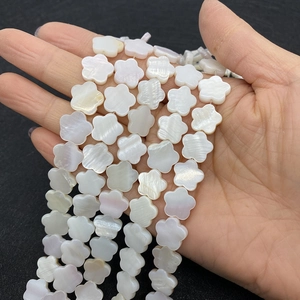 Macro shot of 12mm natural white shell five-petal flower beads for jewelry making