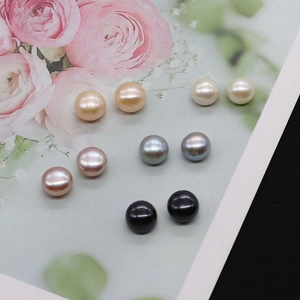 Detailed view of five pairs of colorful natural freshwater pearls on a floral decorative card