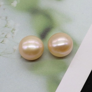 Detailed close-up of two natural round pink champagne pearls for jewelry DIY