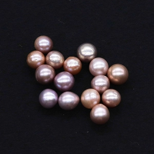 Macro shot of colorful 9-14mm Edison freshwater pearls in natural pink and purple tones
