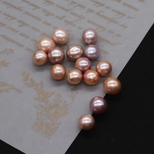 Detailed view of mixed pastel Edison freshwater pearls scattered on vintage craft paper
