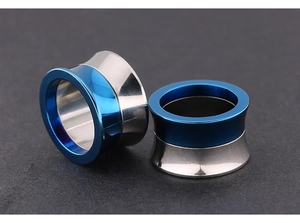 Macro detail of bicolored hip hop ear gauges with blue and silver polished stainless steel