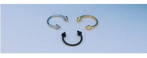 Three circular barbells in silver, gold, and black with sharp spikes on a blue background