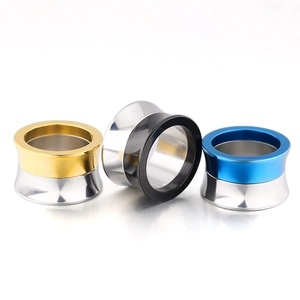 Surgical stainless steel ear expanders in two-tone gold, black, and blue finishes