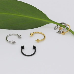 Polished stainless steel horseshoe rings with cone ends in silver gold and black tones