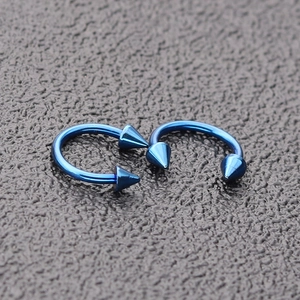 Blue stainless steel horseshoe barbell piercing rings with spiked ends for lip and nose