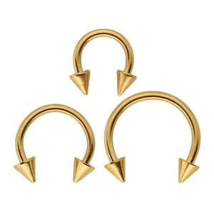 Set of three golden stainless steel circular barbells with spike ends in various sizes
