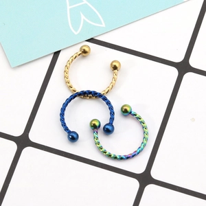 Three-piece twisted horseshoe piercing set in gold, blue, and rainbow stainless steel