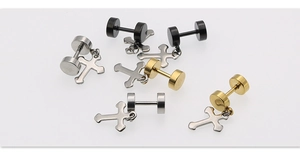 Close-up of stainless steel cross barbell studs in silver, gold, and black finishes