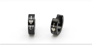 Detail of black stainless steel huggie earrings featuring white I love U heart pattern