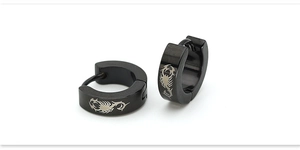Detail of black stainless steel hoop earrings featuring intricate scorpion engraving
